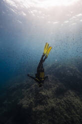 Woman doing scuba diving undersea - RSGF00881