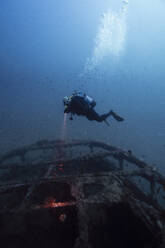 Man examining sunken ship El Naranjito undersea - RSGF00889