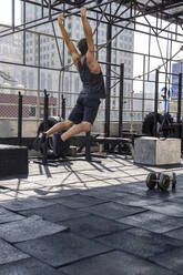 Man doing Calisthenics at rooftop gym - IKF00673