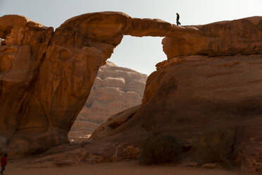 Junge Frau beim Spaziergang auf der Burdah-Brücke, Wadi Rum, Jordanien - PCLF00578