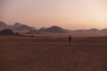 Junge Frau spaziert in der Wüste bei Sonnenuntergang - PCLF00601