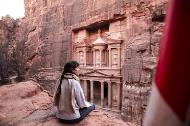 Young woman sitting in front of Al-Khazneh treasury, Petra, Jordan - PCLF00605