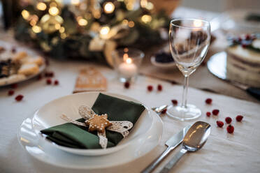 A close-up of plate on decorated table set for dinner meal at Christmas time. - HPIF18670