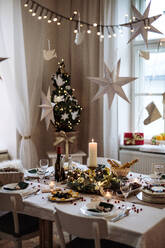 Ein geschmückter Tisch, gedeckt für das Abendessen zur Weihnachtszeit. - HPIF18674