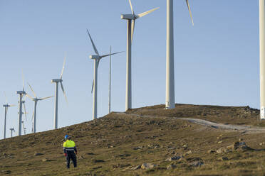 Engineer standing near wind turbines - SNF01679