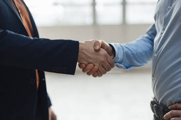 Businessman shaking hands with colleagues at industry - JOSEF19312