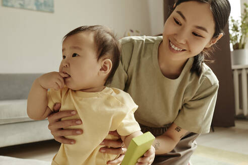 Lächelnde Mutter verbringt ihre Freizeit mit ihrer Tochter zu Hause - KPEF00017