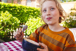 Blond boy eating desert in bowl - IHF01367