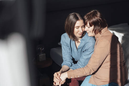 Woman sitting with lesbian friend at home - JOSEF19462