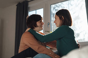 Affectionate lesbian couple looking at each other - JOSEF19485