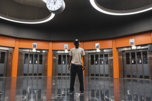 Young man using Virtual Reality Simulator at Metro Station - PNAF05302