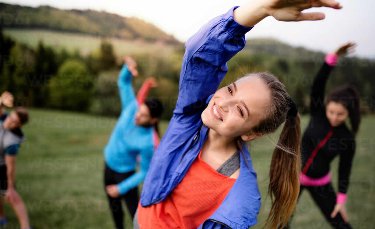 group of people exercising with background landscape vector