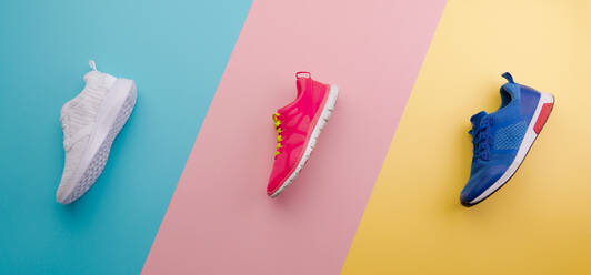 A studio shot of pair of running shoes on red background. Flat lay, top  view. stock photo