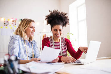 Young creative women with laptop working in a studio, startup business. - HPIF19566