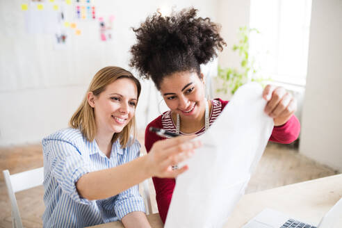 Young creative women working in a studio, startup business. - HPIF19568