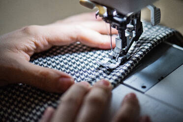 Unrecognizable young creative woman using sewing machine, startup business. Close up. - HPIF19584