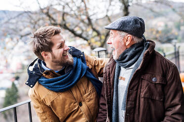 Senior father and his young son on a walk in town, having fun. - HPIF19887