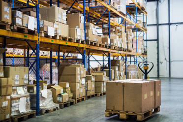 An interior of a warehouse with shelves and pallet truck. - HPIF20003