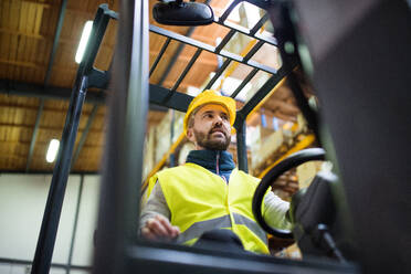 Man forklift driver working in a warehouse. - HPIF20026