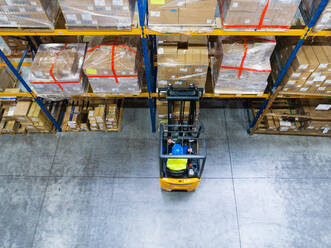 Man forklift driver working in a warehouse. Aerial view. - HPIF20034