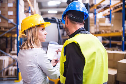 Junge Arbeiter arbeiten gemeinsam in einem Lagerhaus. - HPIF20074