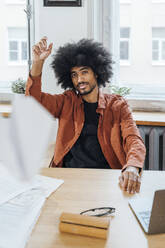 Freelancer throwing paper plane sitting at home - VPIF08240