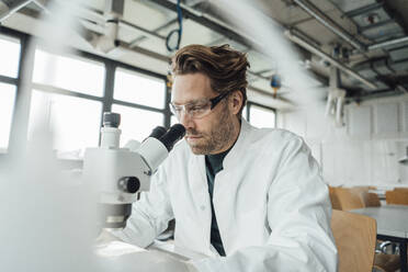 Mature scientist working on microscope - JOSEF19600