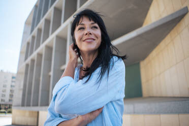 Contemplative businesswoman with hand in hair - JOSEF19690