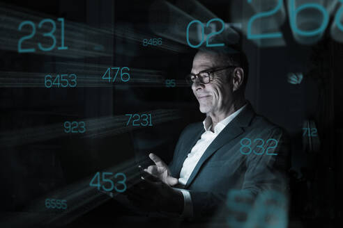 Businessman looking at numbers on graphical user interface - UUF28775