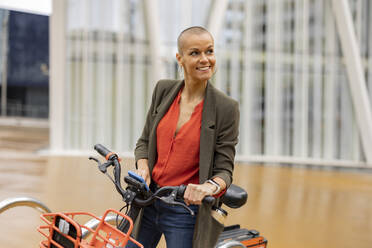 Woman with bicycle on street - JCCMF10435