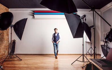 Portrait of a young handsome hipster man posing in a studio. Copy space. - HPIF21128