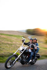 Ein fröhliches älteres Ehepaar reist mit dem Motorrad auf dem Land. Platz zum Kopieren. - HPIF21833