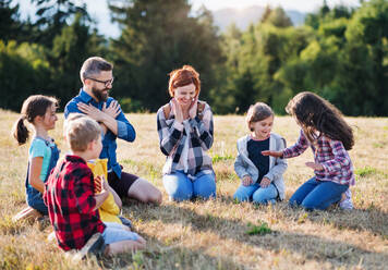 A group of small school children with teacher on field trip in nature. - HPIF22188