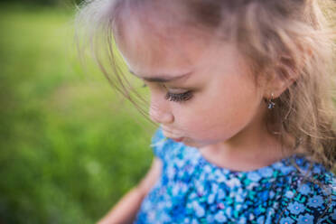 A portrait of a small girl in the garden in spring nature. Copy space. Close up. - HPIF22645