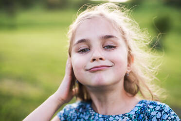 A portrait of a small girl in the garden in spring nature. Close up. - HPIF22646