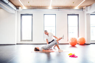 Senior physiotherapist working with an old female patient. - HPIF22652