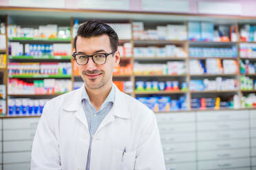 Portrait of a young atrractive friendly male pharmacist. - HPIF22996