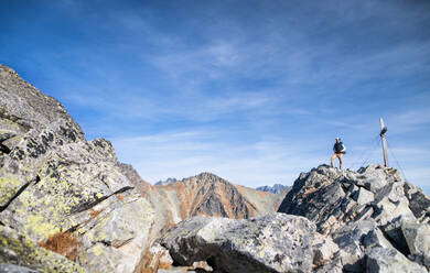 Mature man with backpack hiking in mountains in autumn, resting. Copy space. - HPIF23272