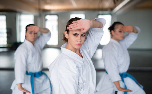 Eine Gruppe junger Frauen übt in einer Turnhalle Karate. - HPIF23357