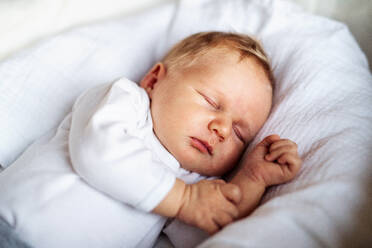 A close-up of a cute sleeping newborn baby at home. - HPIF24084