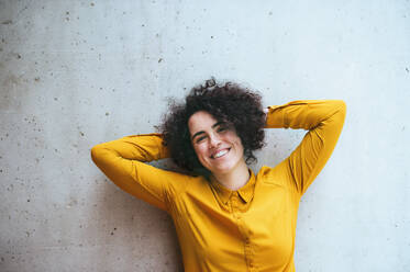 A portrait of a young student or businesswoman standing in room in a library or office. - HPIF24478