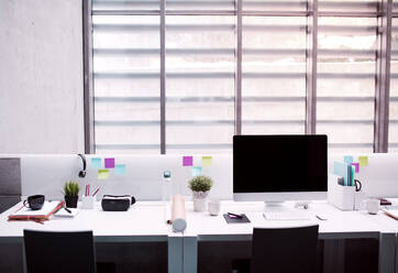 A desk with computer in interior of modern spacious office. - HPIF24622