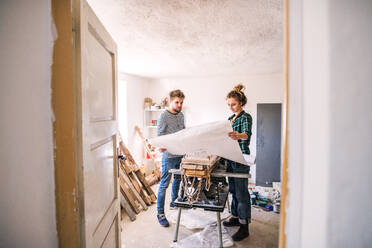 Small business of a young couple. Man and woman worker in the carpenter workroom. - HPIF25148