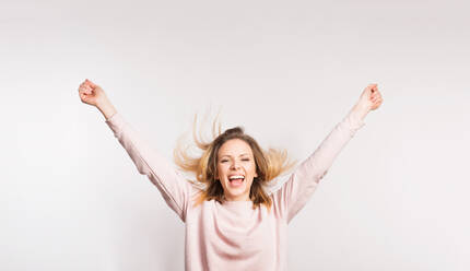 Portrait of a young delighted beautiful woman in studio. White background. Copy space. - HPIF25353