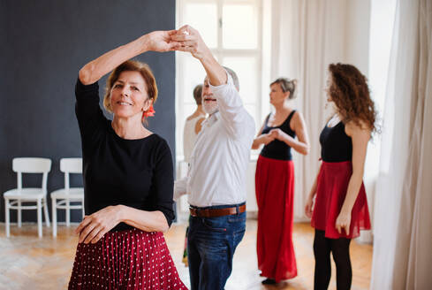 Eine Gruppe älterer Menschen besucht einen Tanzkurs mit einem Tanzlehrer. - HPIF25711