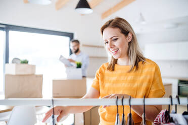 A young happy couple furnishing new house, a moving in new home concept. - HPIF25964