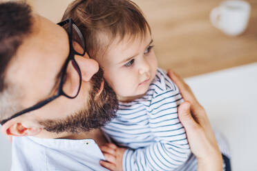 A top view portrait of mature father with a toddler girl standing indoors. - HPIF26049