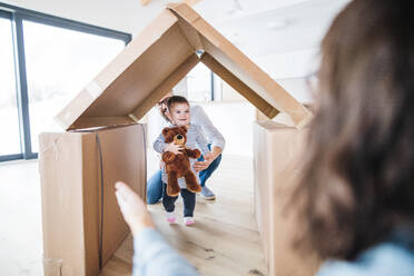 Eine junge Familie mit einem glücklichen kleinen Mädchen im Haus, das ein neues Hauskonzept bezieht. - HPIF26059
