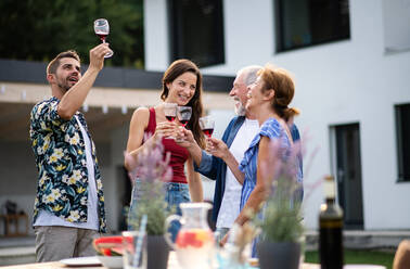 Porträt von Menschen mit Wein im Freien auf Familie Garten Grill, klirren Gläser. - HPIF26456