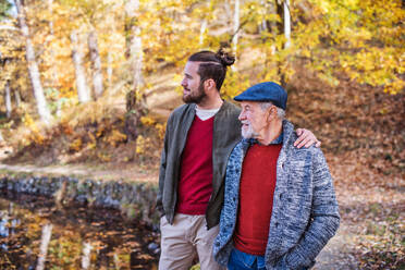 Senior father and his young son walking in nature, talking. - HPIF26747